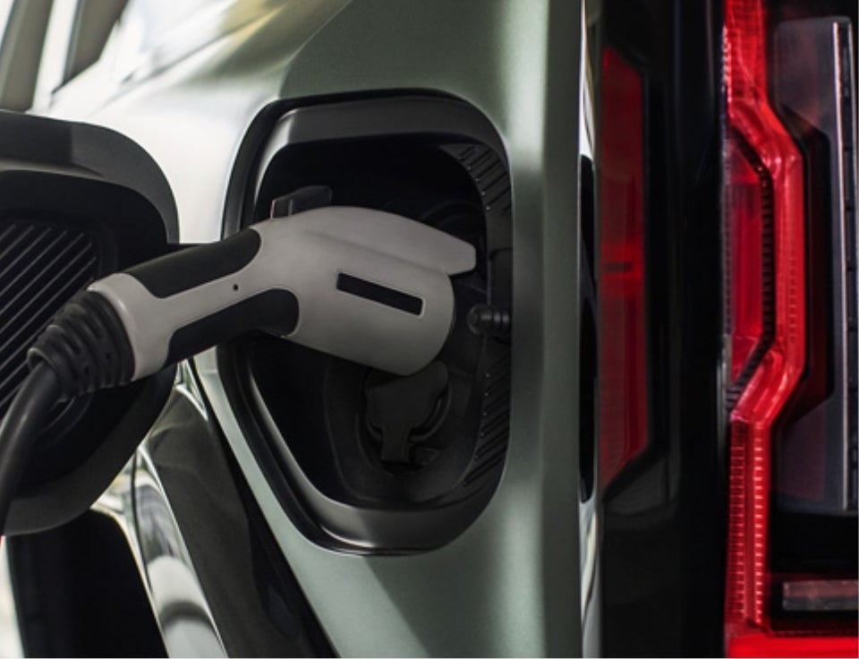 Close up of charging port with charger plugged in on a GMC Hummer EV SUV - Williamson Buick GMC in Miami FL